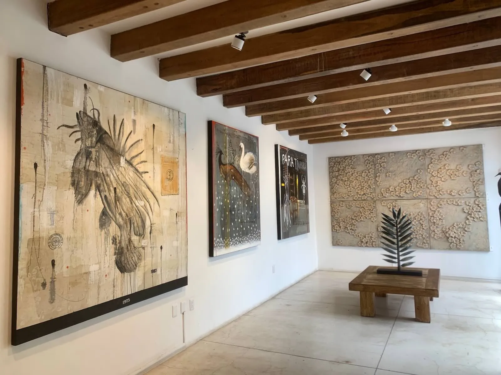 Amador Montes in his Oaxaca studio, with layered paintings and earthy color studies
